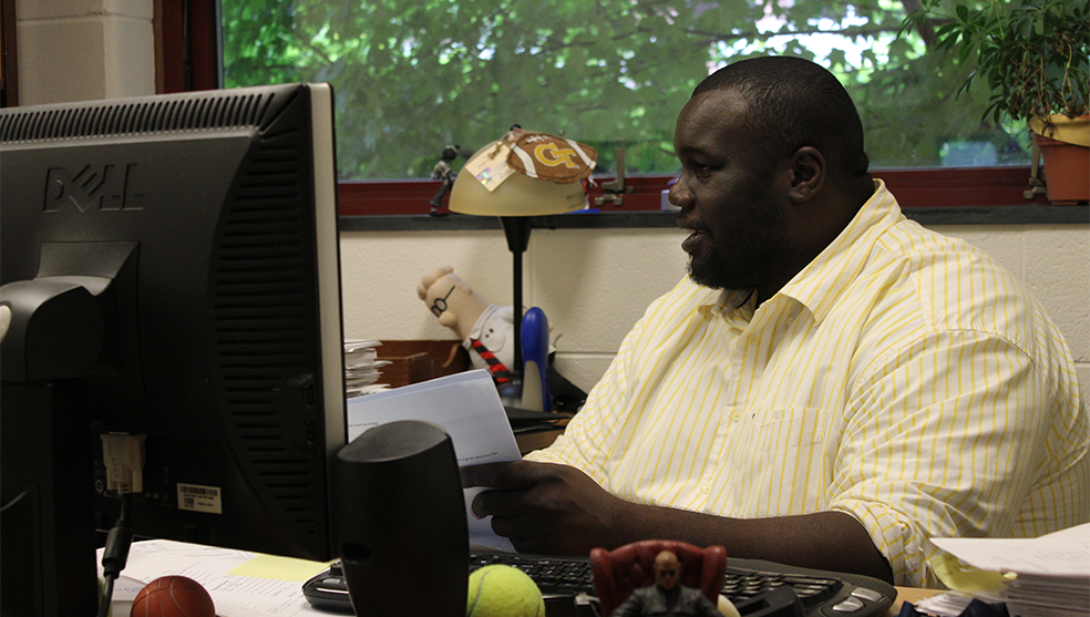 Image of man sitting behind monitor at desk